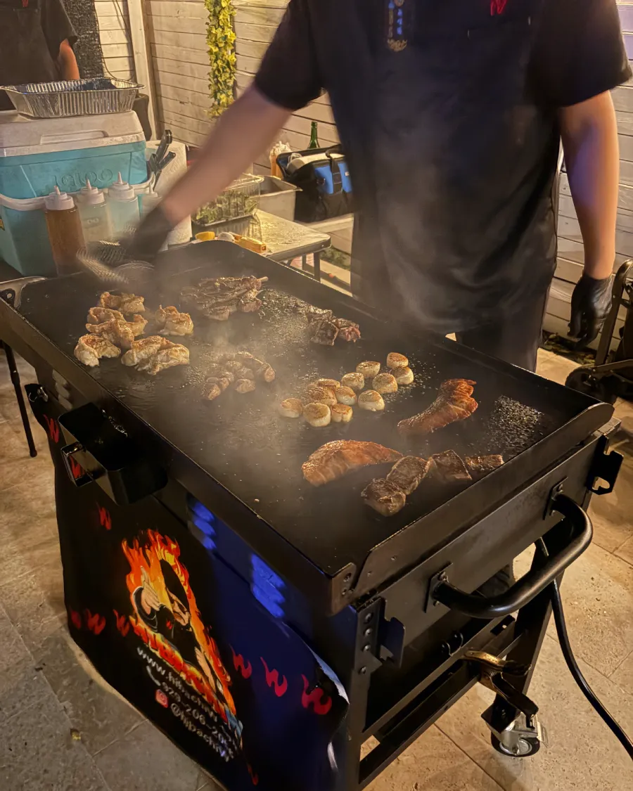 Private hibachi chef cooking and interacting with guests