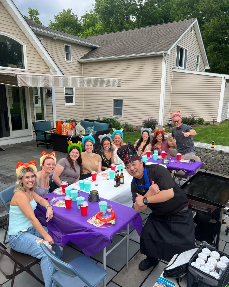 Private hibachi chef with guests at a backyard hibachi at home gathering in Washington DC