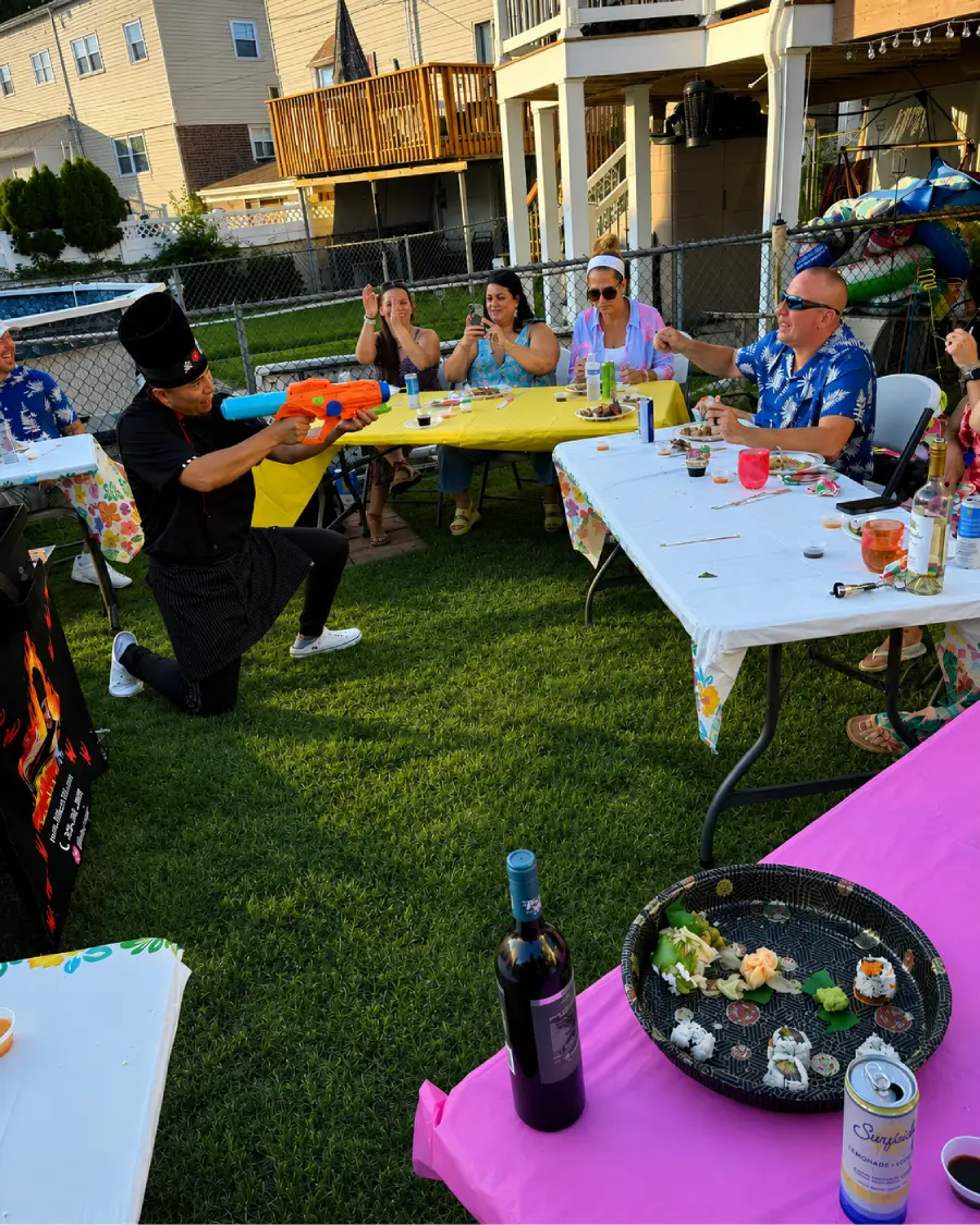 Private hibachi chef interacting with guests during a backyard hibachi at home experience in Washington DC