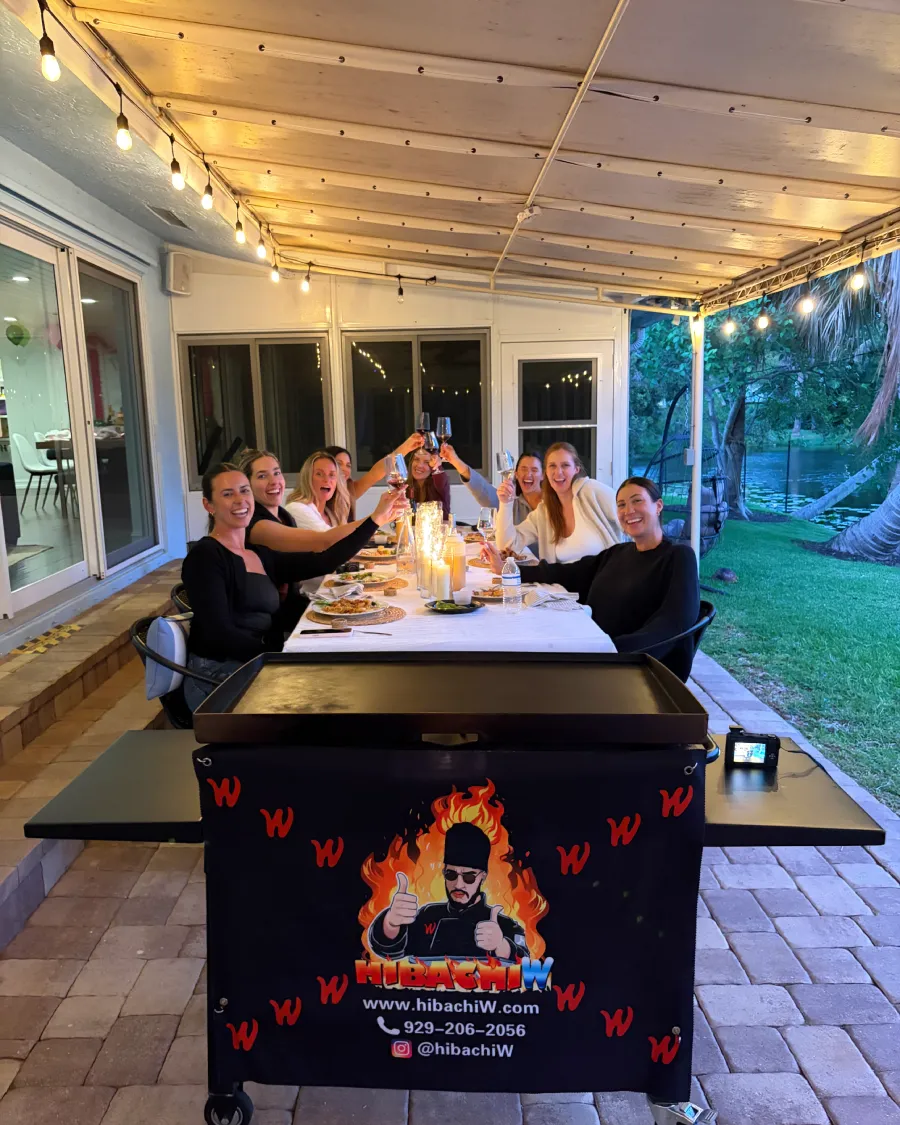 Guests enjoying a backyard hibachi at home dinner in Edison, NJ
