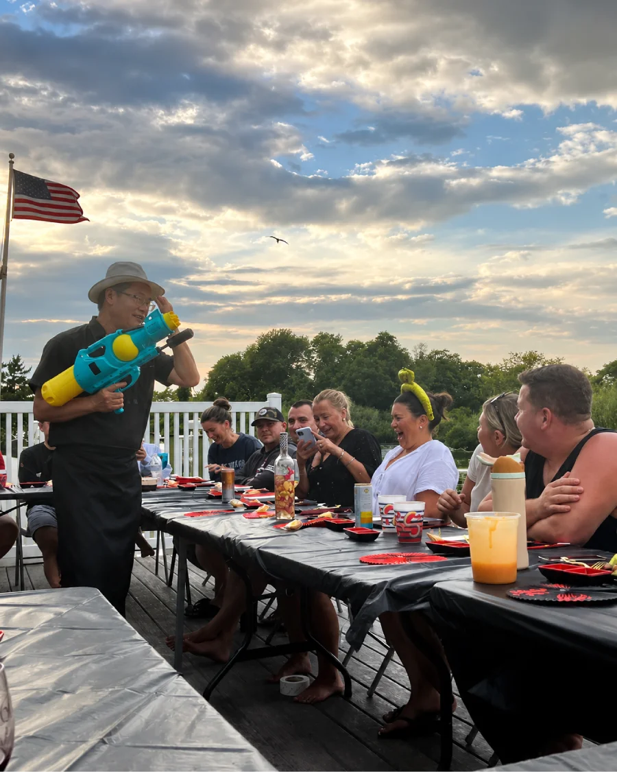 Private hibachi chef entertaining guests during an outdoor dinner across Finger Lakes