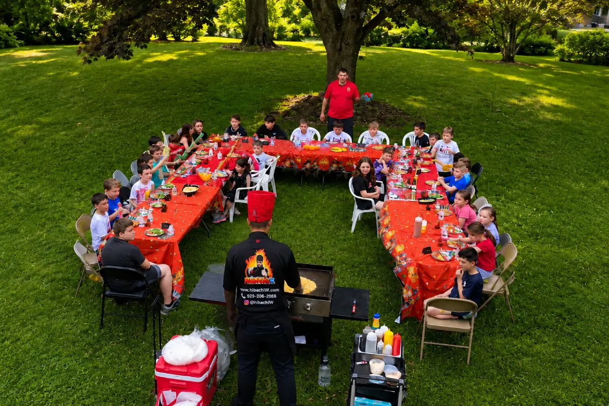 Kids enjoying a backyard hibachi party with a private chef cooking live