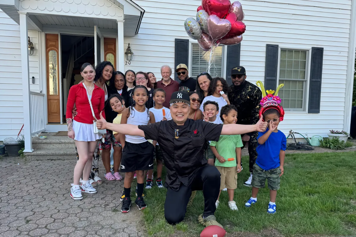 Private hibachi chef celebrating with families and children at an outdoor birthday party