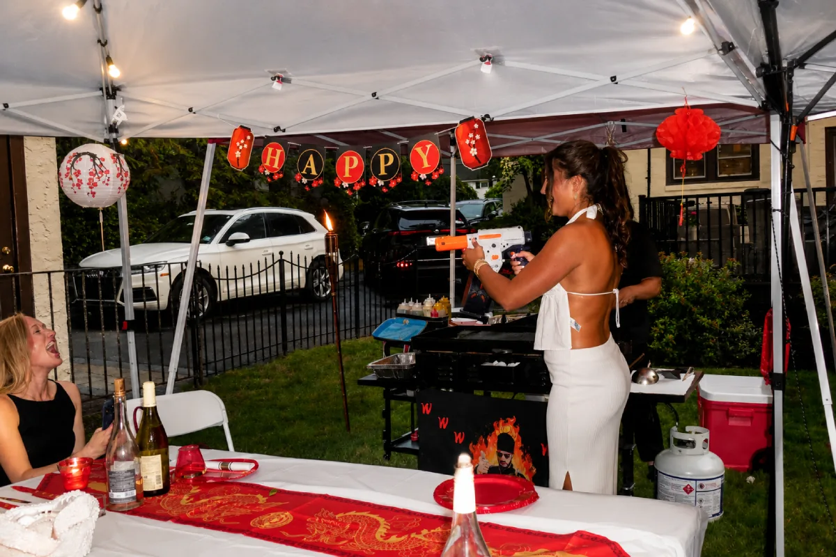 Guests interacting during an outdoor hibachi party in Texas
