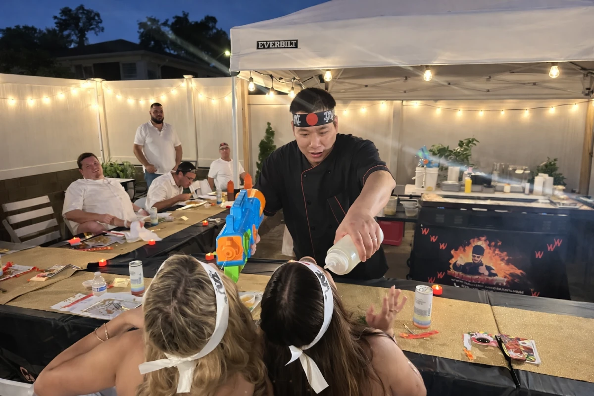 Private hibachi chef entertaining guests during a hibachi at home experience