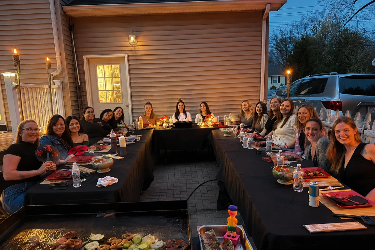 Guests enjoying a large hibachi at home group dinner with a private chef