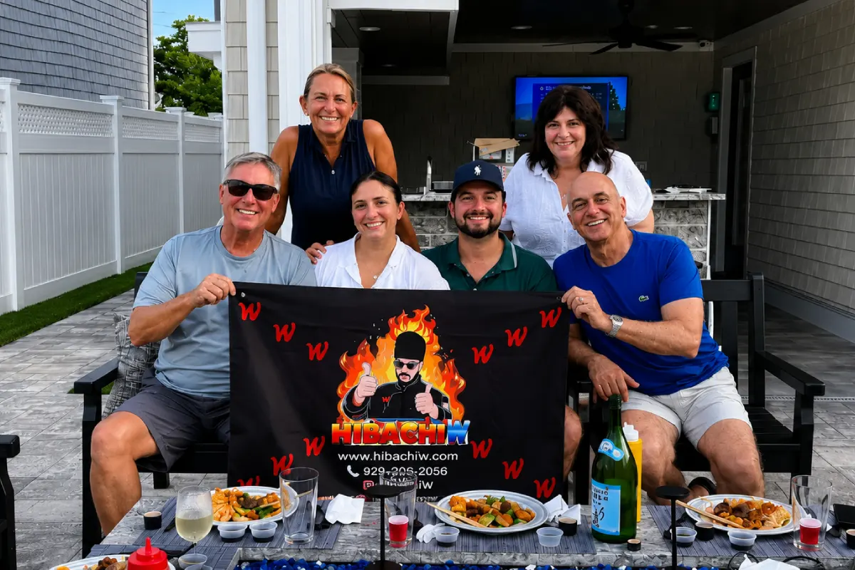 Guests enjoying a private hibachi at home dinner with freshly prepared food