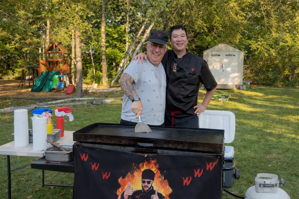 private hibachi chef with happy guest during a Father's Day hibachi at home backyard experience
