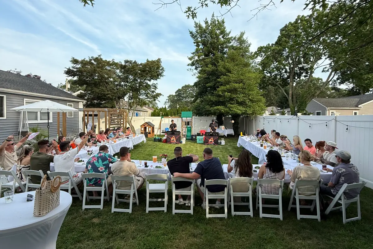 large hibachi at home Father's Day backyard dinner with guests seated around a group dining setup
