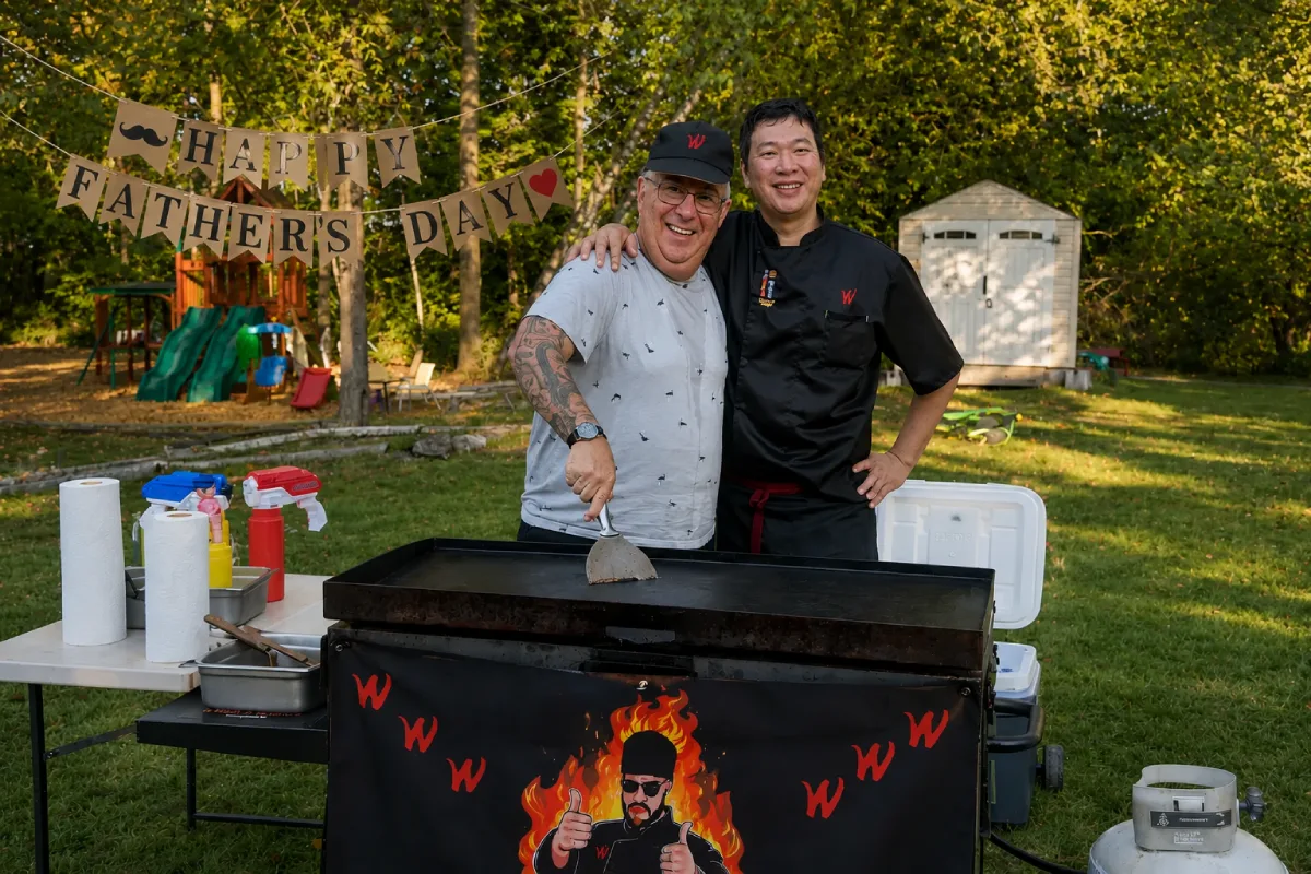 Father's Day hibachi at home guest posing with a private hibachi chef in a backyard setting