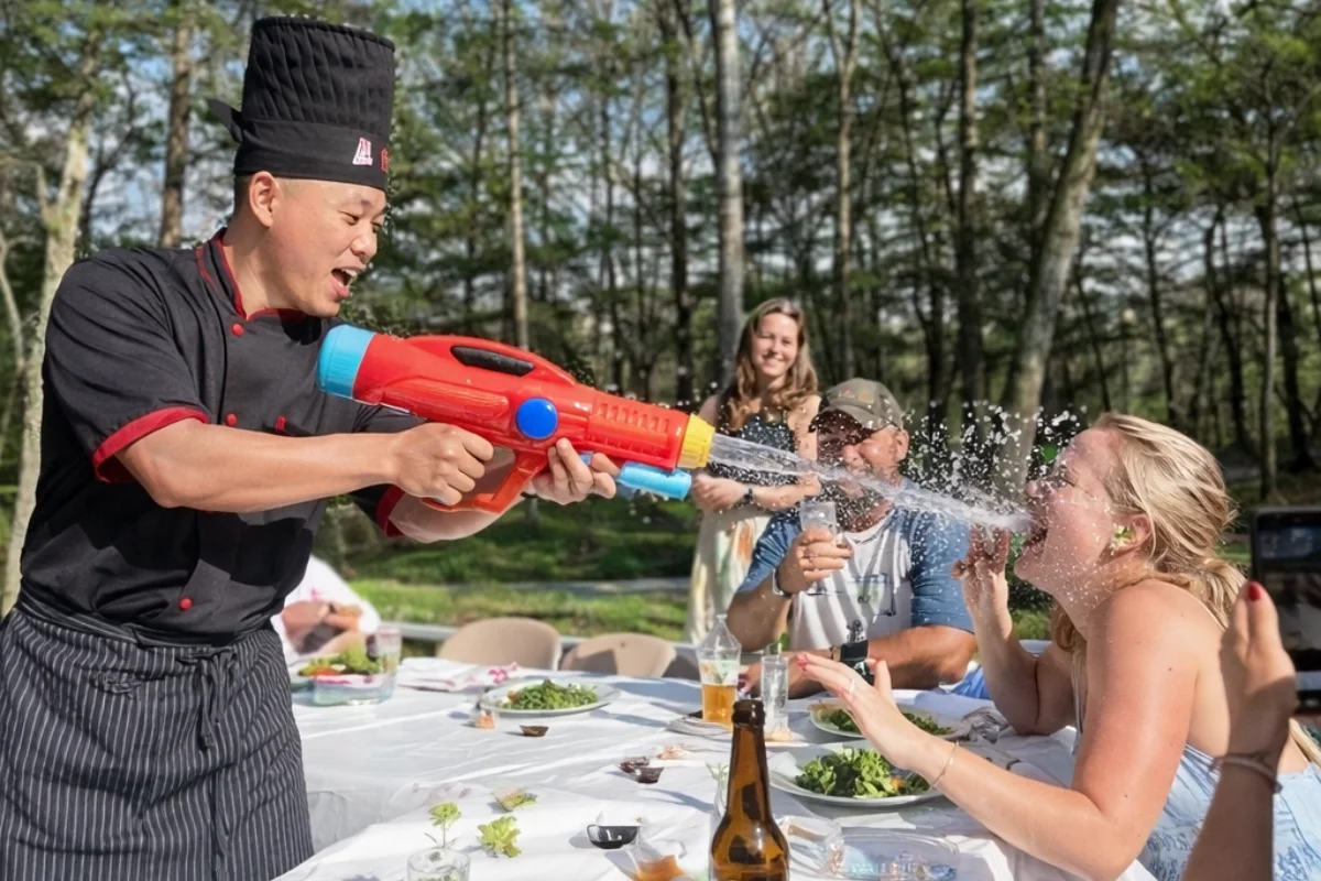 Private hibachi chef entertaining guests during a backyard hibachi party in New Jersey