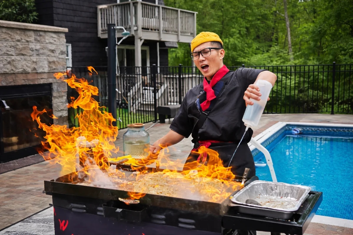 Private hibachi chef performing a fire show in a New Jersey backyard